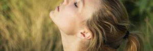 woman outside with her head tilted up