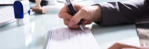 person signing a check