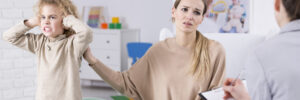 woman with her son talking to a doctor