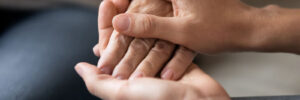 Two People Holding Hands Up Close