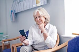 looking at phone while waiting in doctor's office waiting room