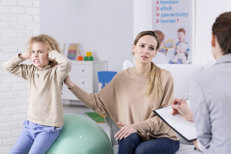 woman with her son talking to a doctor