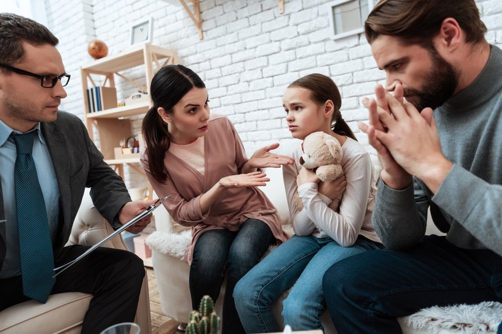 Family looking stressed and working with a family counselor