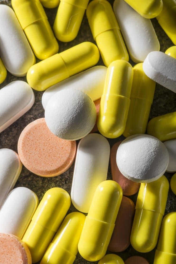 A mixture of yellow, white, and beige pills