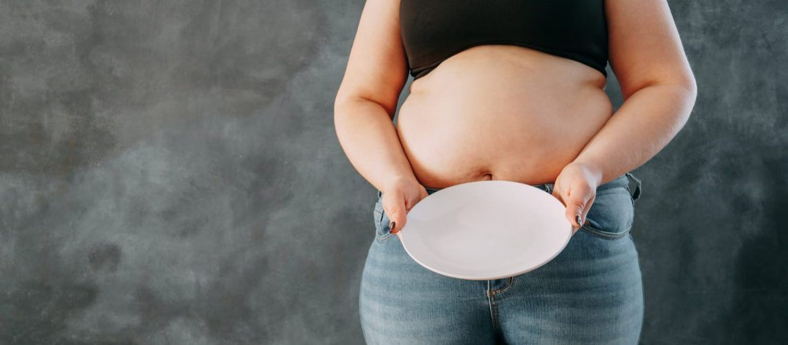 Plus size woman with empty plate